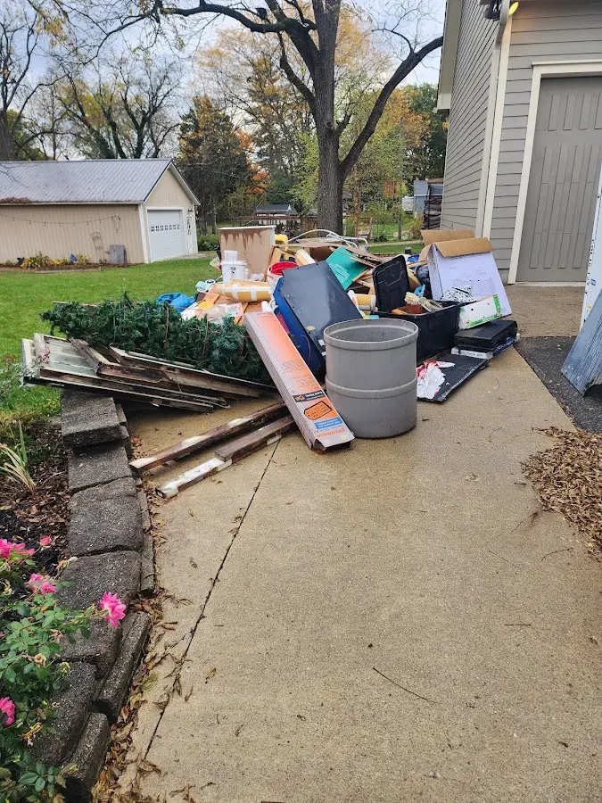 Dumpster being loaded with debris for Estate Cleanout Dumpster Rental in West Union